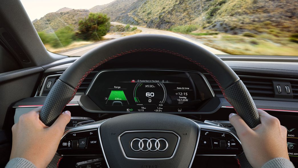 Audi Q8 e-tron steering wheel with view on the country road