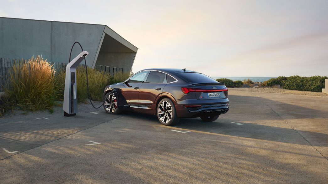 Audi Q8 e-tron Sportback at a charging station side and rear view
