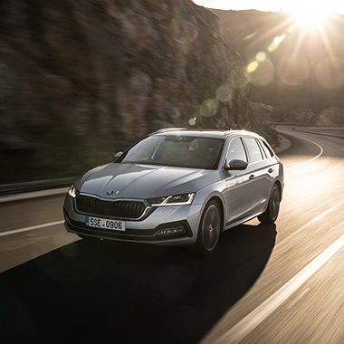 Grey Škoda Octavia on a mountain street front and side view