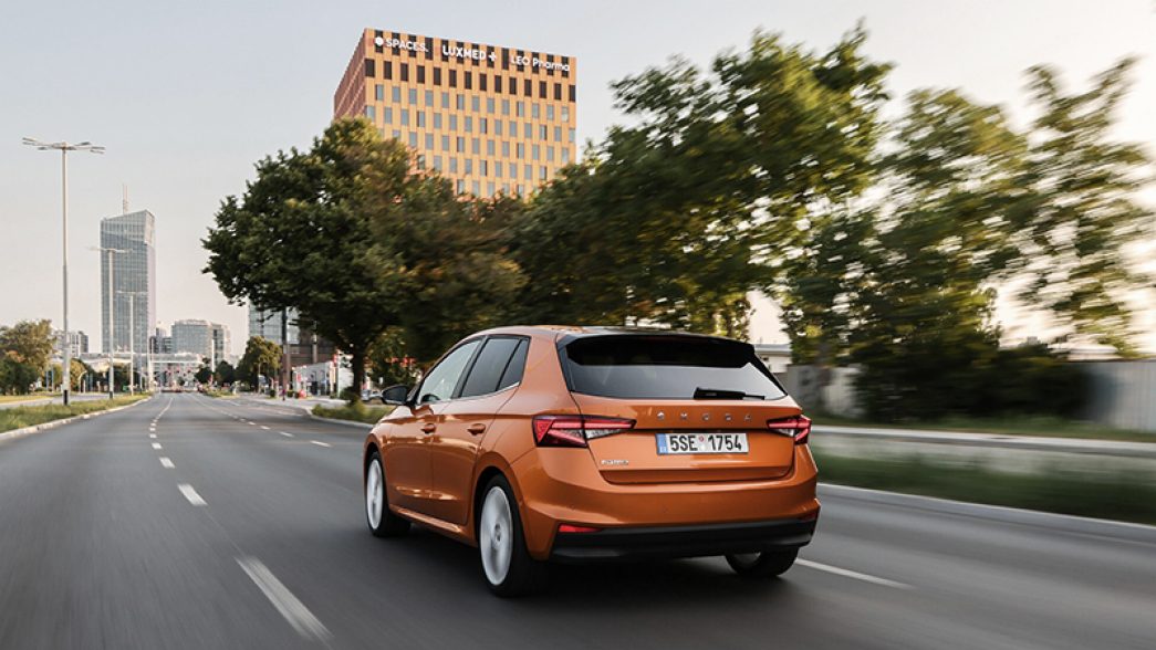 Orange Škoda Fabia on the street rear view