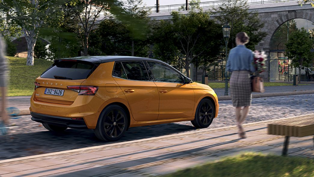 Parked, orange Škoda Fabia side and rear view
