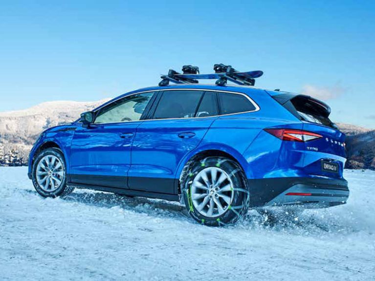 Car in snow with snowboard roof rack 